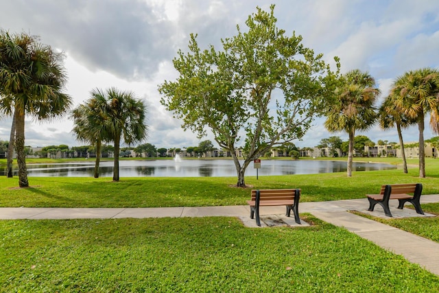 view of community with a water view and a yard