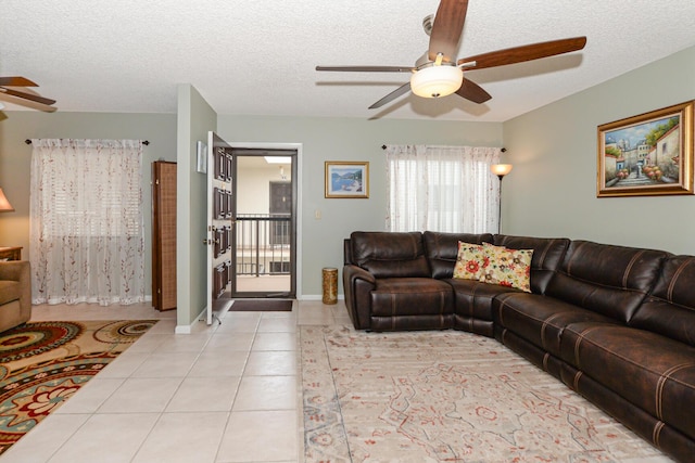 tiled living room with a textured ceiling and ceiling fan