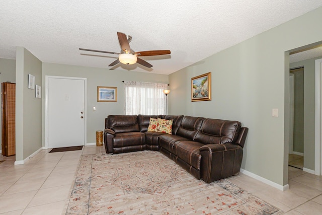 tiled living room with ceiling fan and a textured ceiling