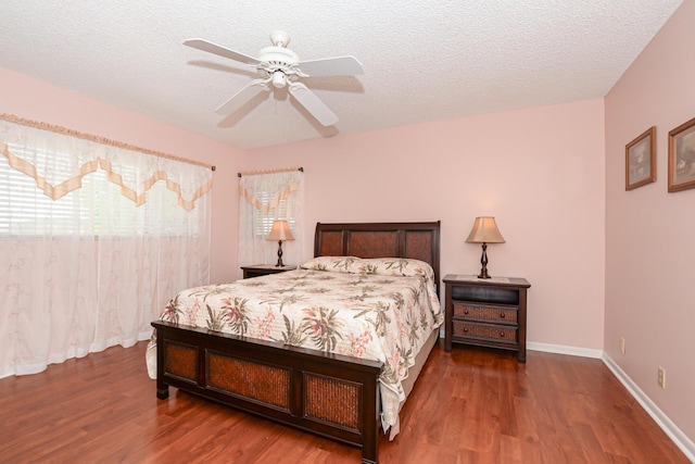 bedroom featuring ceiling fan, wood-type flooring, and a textured ceiling