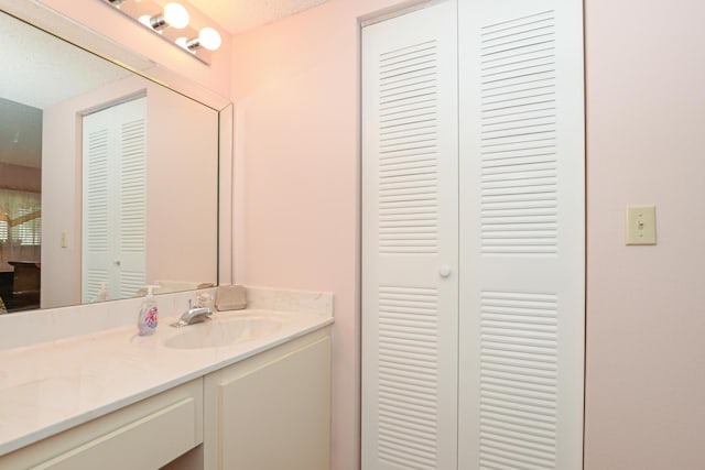 bathroom with a textured ceiling and vanity