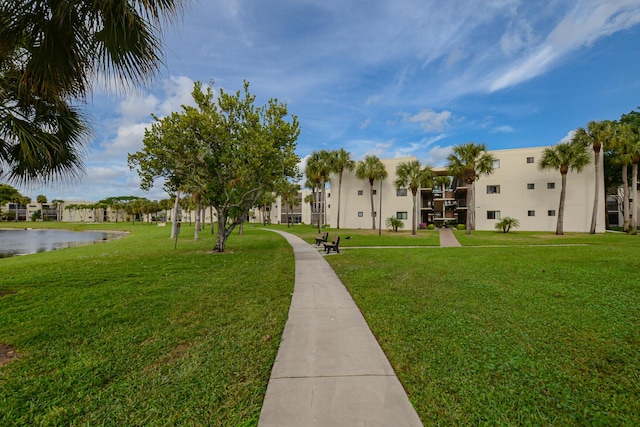 view of home's community with a yard and a water view