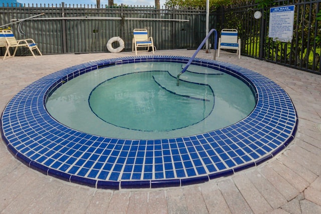 view of pool featuring a hot tub