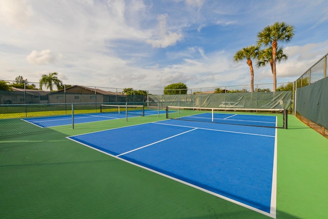 view of tennis court with basketball hoop