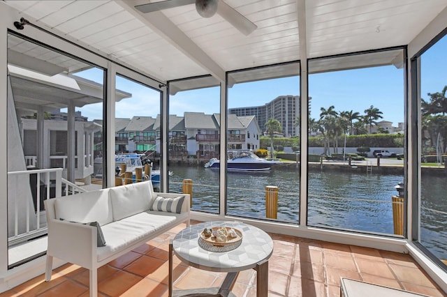 sunroom / solarium with ceiling fan, beam ceiling, a water view, and wood ceiling