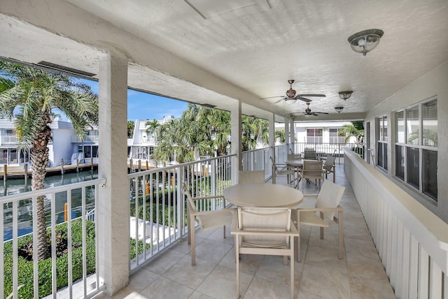 unfurnished sunroom with ceiling fan and plenty of natural light