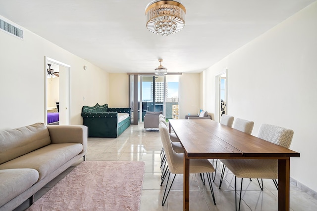 tiled dining space with a chandelier