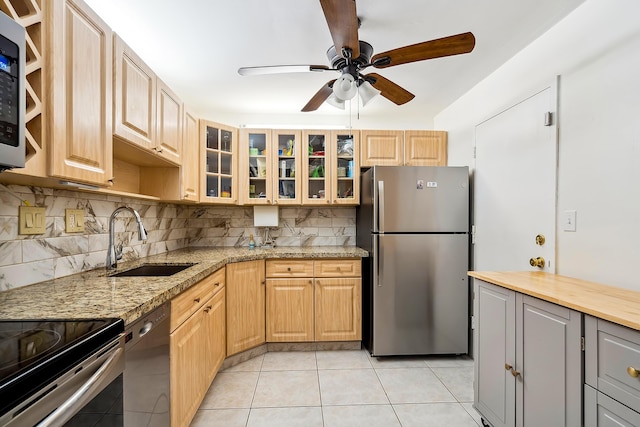 kitchen featuring light tile patterned floors, stainless steel appliances, tasteful backsplash, and sink