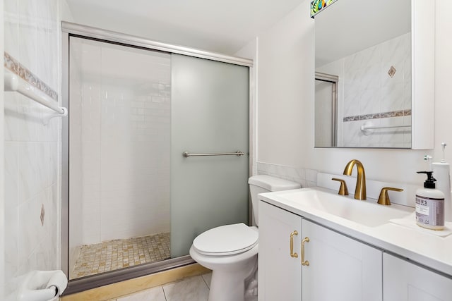 bathroom with tile patterned flooring, vanity, toilet, and an enclosed shower