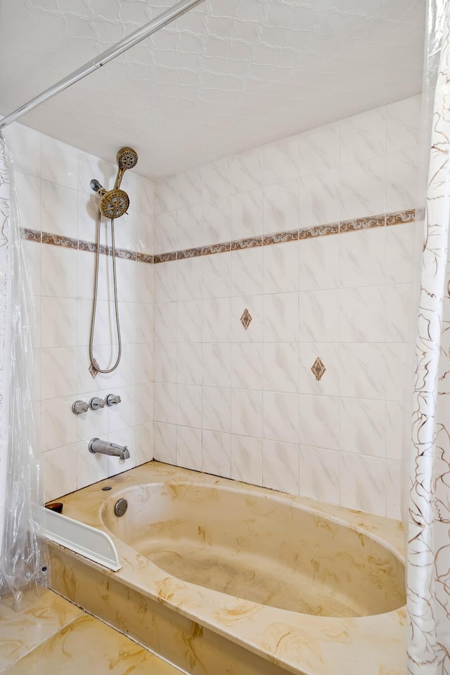 bathroom with shower / bath combination with curtain