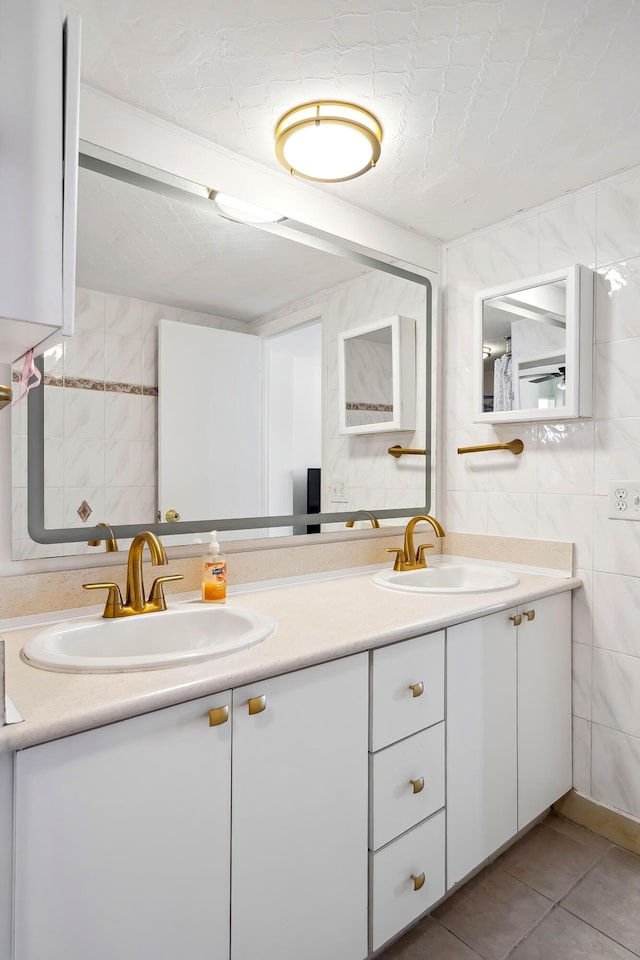 bathroom with tile patterned floors, vanity, and tile walls