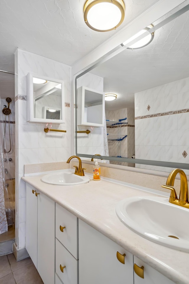 bathroom with tile patterned flooring, vanity, and tile walls