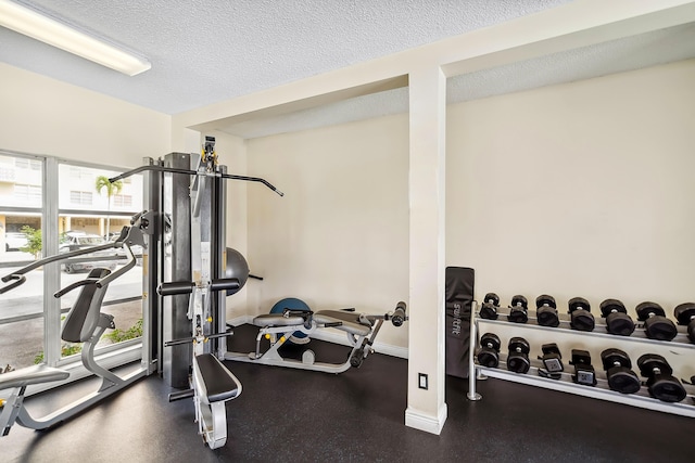 workout area with a wealth of natural light and a textured ceiling