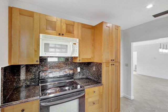 kitchen with black electric range oven, decorative backsplash, and dark stone counters