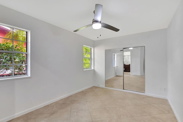 unfurnished bedroom with a closet, ceiling fan, and light tile patterned flooring