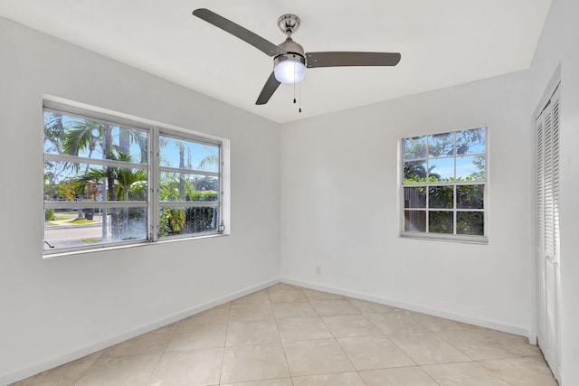 unfurnished bedroom featuring light tile patterned floors, ceiling fan, and a closet