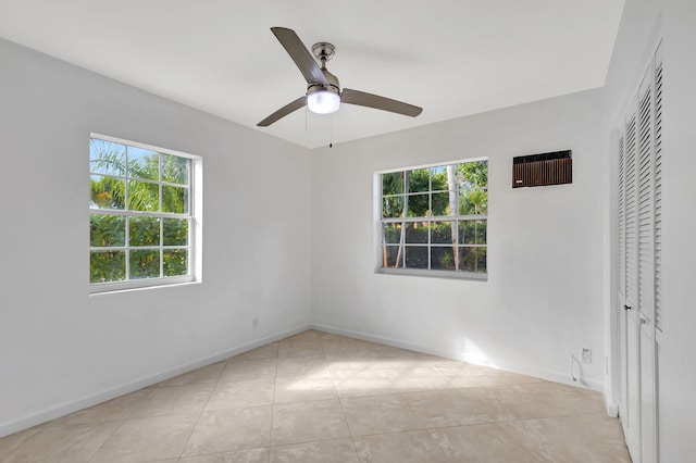 unfurnished bedroom with light tile patterned flooring, ceiling fan, and a closet