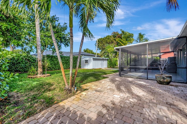 view of yard featuring a patio area and a sunroom