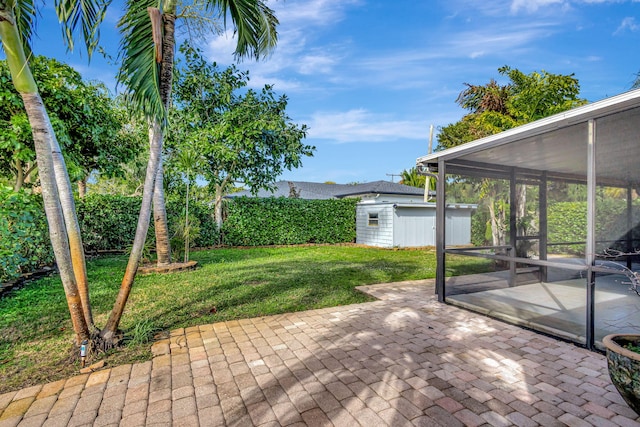 view of patio featuring a sunroom and a shed