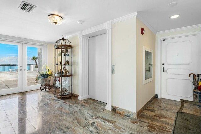 foyer with crown molding and french doors