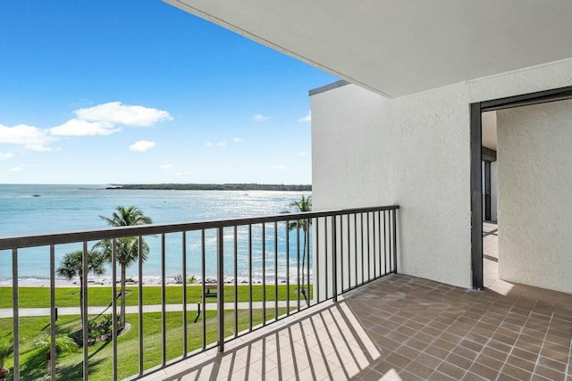 balcony with a water view and a beach view