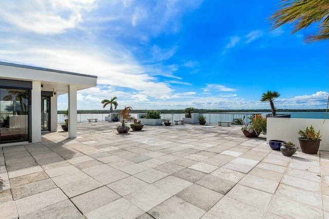 view of patio with a water view