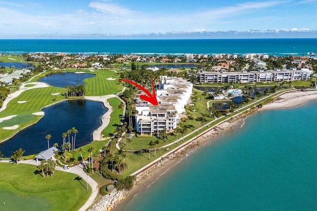 bird's eye view with a water view and a view of the beach