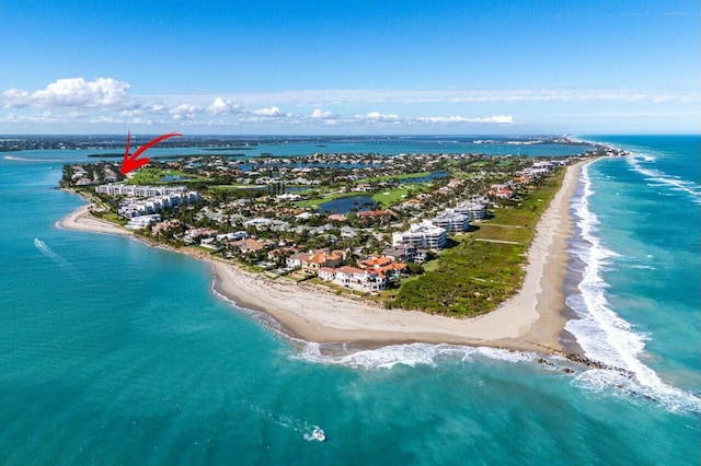 aerial view with a water view and a beach view