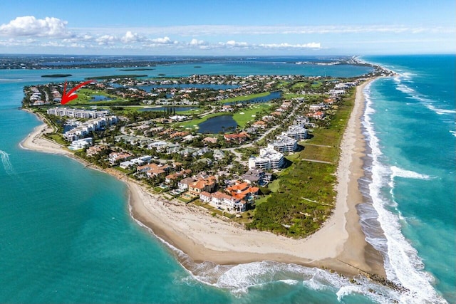 bird's eye view featuring a water view and a beach view