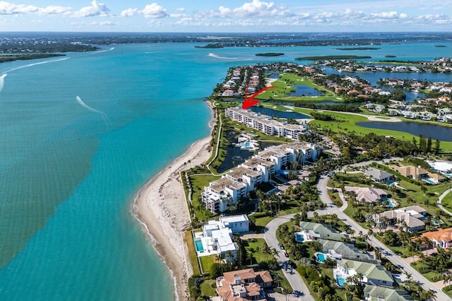 bird's eye view featuring a water view and a view of the beach