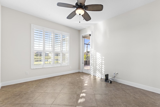 empty room featuring light tile patterned floors and ceiling fan