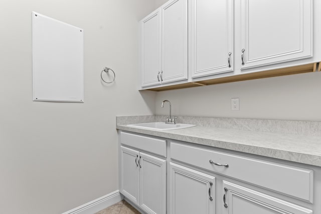 laundry area with sink and light tile patterned floors