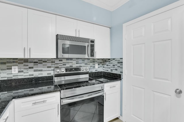 kitchen with white cabinets, dark stone counters, and stainless steel appliances