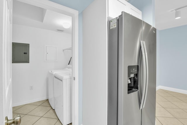 washroom with light tile patterned flooring, washing machine and clothes dryer, and electric panel