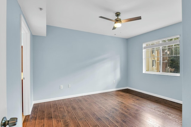 empty room featuring ceiling fan and dark hardwood / wood-style flooring