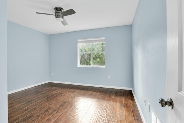 empty room with ceiling fan and dark wood-type flooring