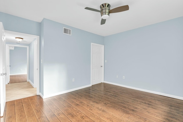 spare room with ceiling fan and hardwood / wood-style flooring