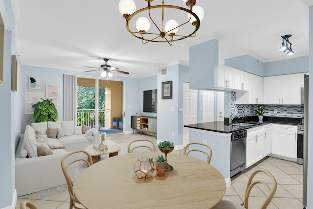 kitchen with ceiling fan with notable chandelier, pendant lighting, white cabinetry, stainless steel appliances, and decorative backsplash