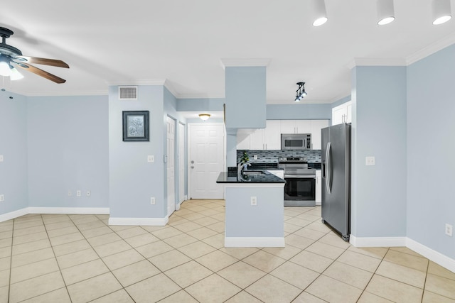 kitchen featuring ceiling fan, white cabinets, appliances with stainless steel finishes, and crown molding