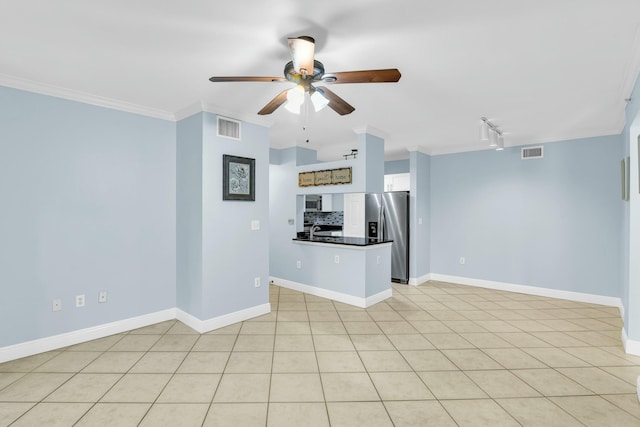 unfurnished living room featuring ceiling fan, light tile patterned flooring, crown molding, and track lighting