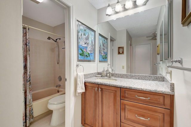 full bathroom with vanity, ceiling fan, toilet, shower / bathtub combination with curtain, and a textured ceiling