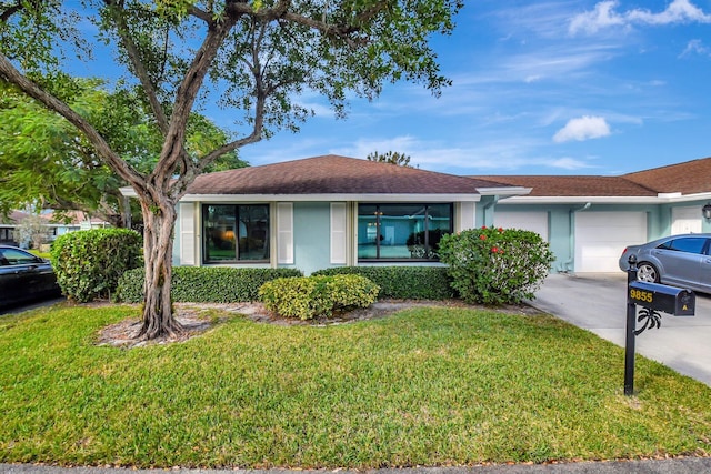ranch-style house with stucco siding, driveway, a front yard, and a garage