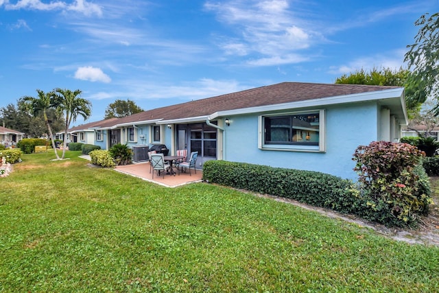 rear view of property featuring a patio and a yard