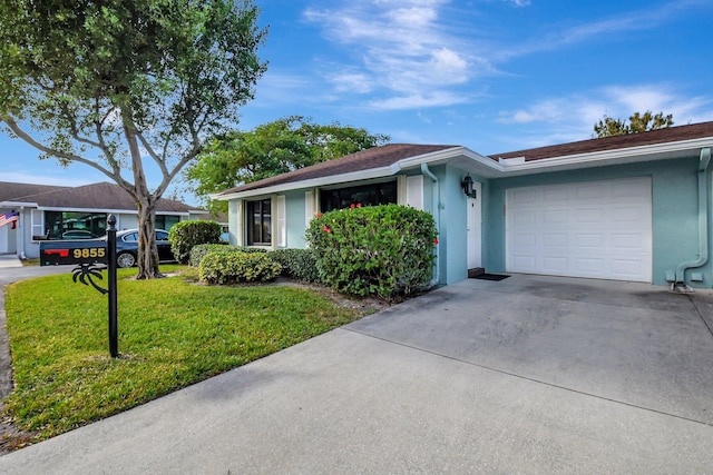 ranch-style house with stucco siding, a front yard, concrete driveway, and a garage