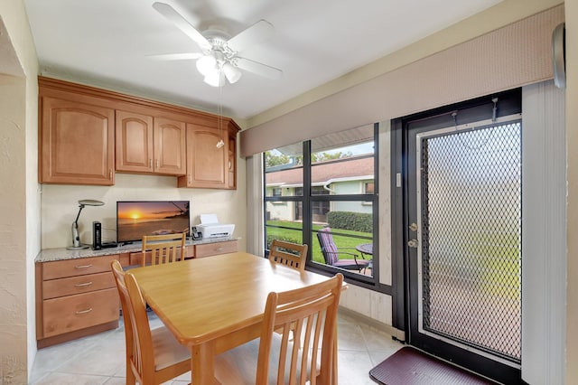 tiled dining room with ceiling fan