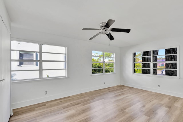 spare room with ceiling fan and light wood-type flooring