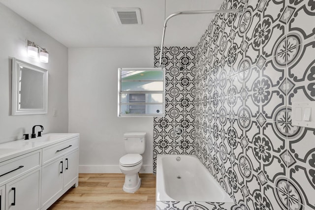 full bathroom featuring toilet, vanity, shower / bathtub combination, and hardwood / wood-style flooring