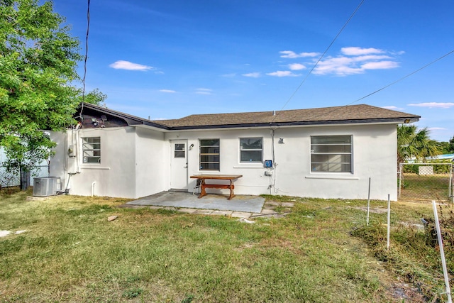 rear view of property with a yard, a patio, and cooling unit