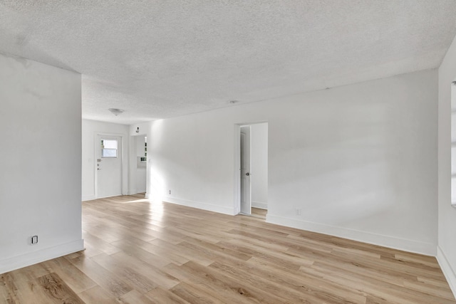 empty room featuring light hardwood / wood-style floors and a textured ceiling