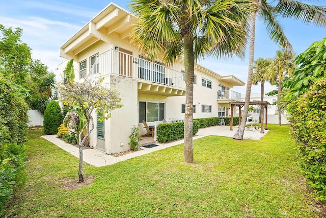 exterior space featuring a balcony and a lawn